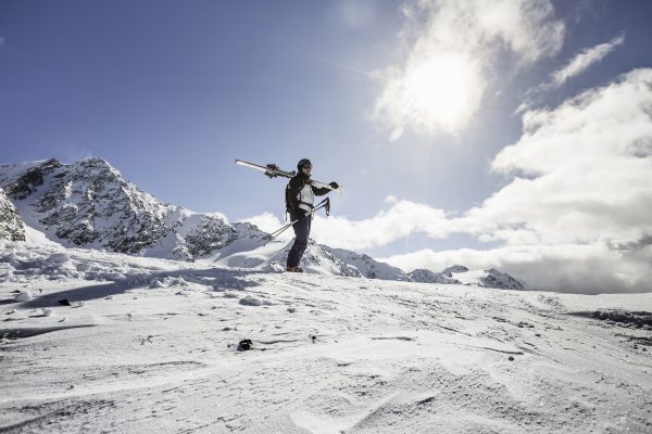 Man in snow holding a snowboard